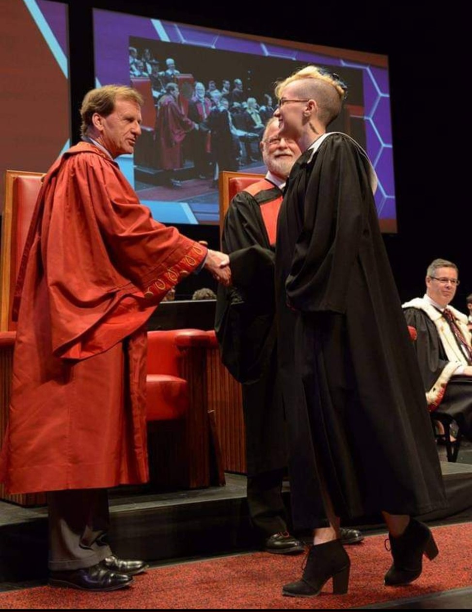 Alex walking the stage at their University of Ottawa convocation in 2015